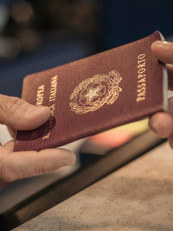 Person handing over passport, close up